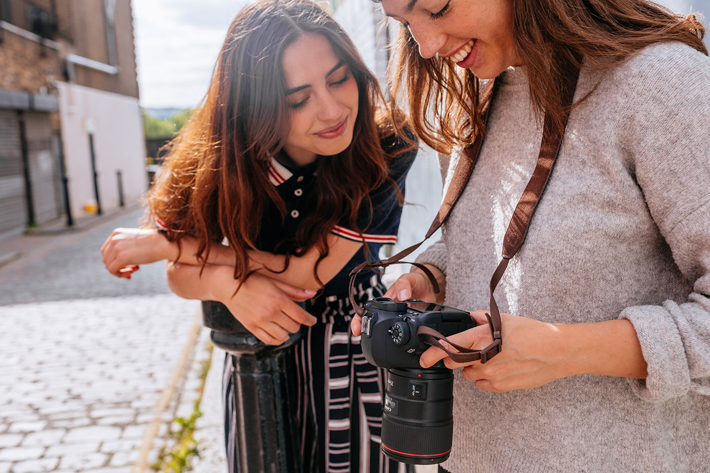 Tow women looking at Canon camera controls