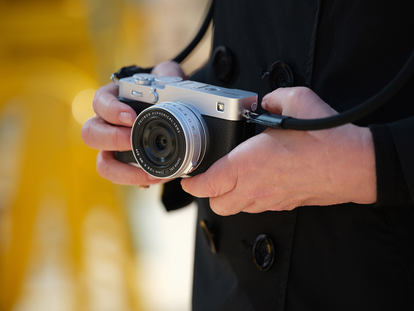 Lifestyle image of the silver X-E5 camera held