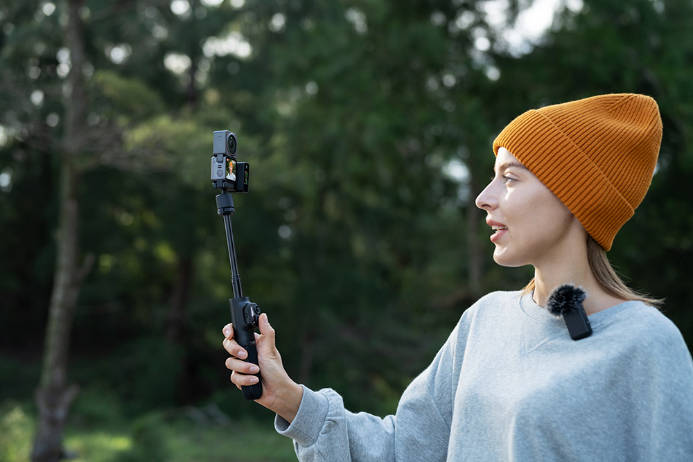 Girl vlogging with acessory tripod, which is a great gift idea!