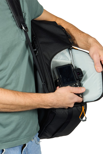 Photographer retrieving a camera through the Fastpack IV side opening