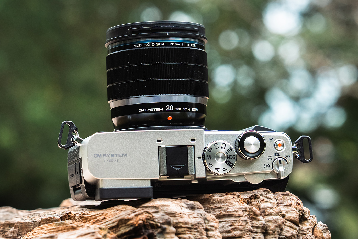 Close-up of the body and lens attached with top plate dials and lever