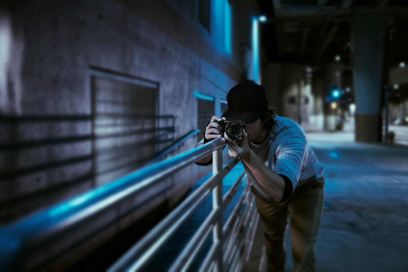 Photo of young Sony creator taking photo at nightime in a city street