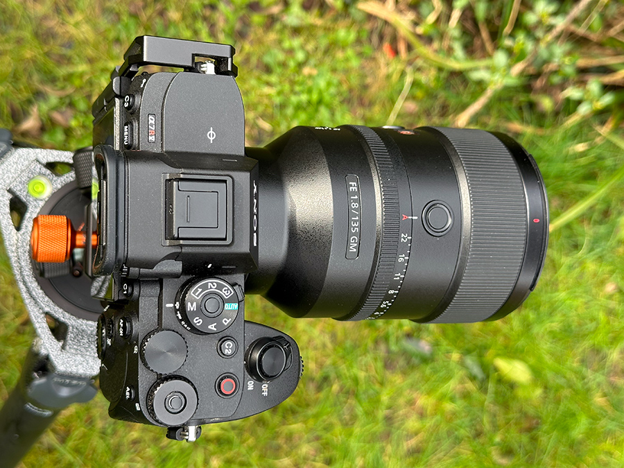 Lens mounted onto camera body with tripod