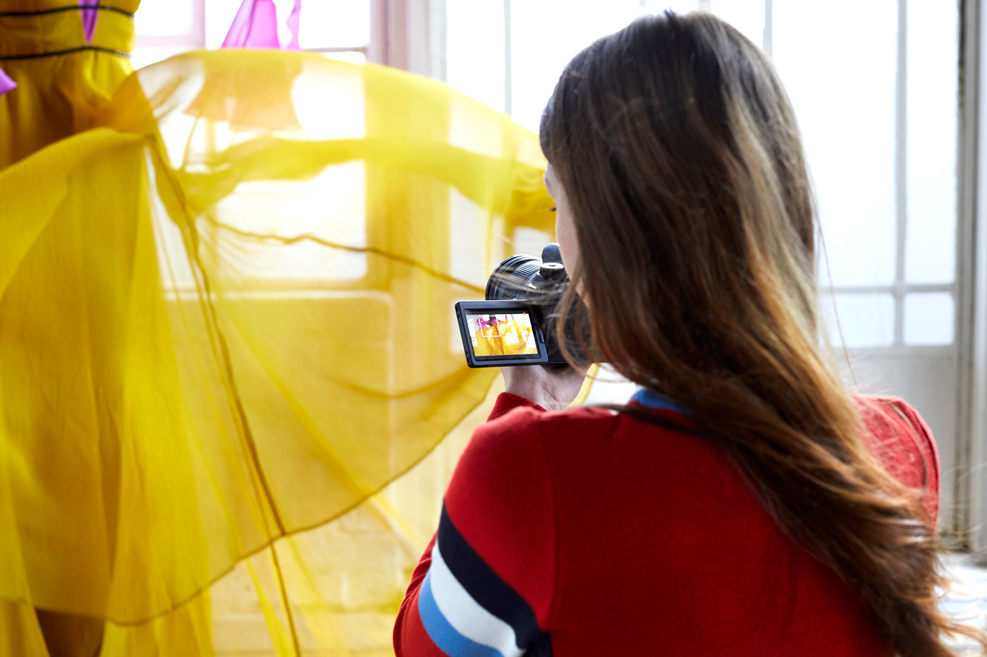 Student capturing images indoors with full frame camera