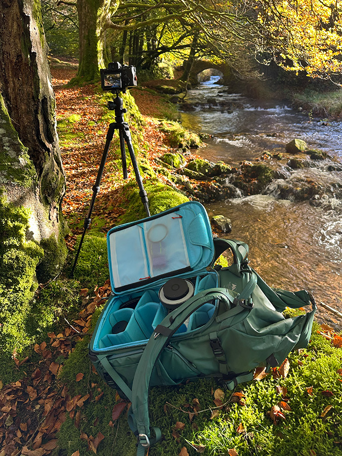 In the field, bag on ground by tripod