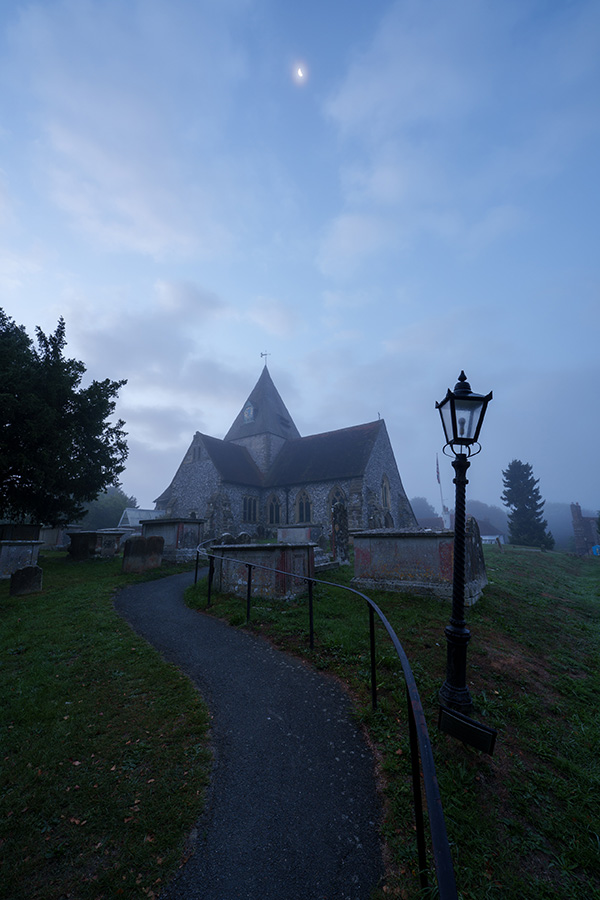 Sample 01 A misty churchyard beneath the moon at 14mm. Camera settings: 2.5 sec. f/8. ISO 100.