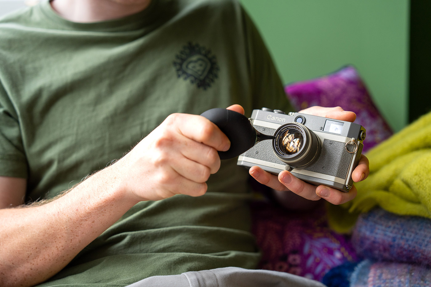 Blowing dust from a film camera lens with the vsgo blower