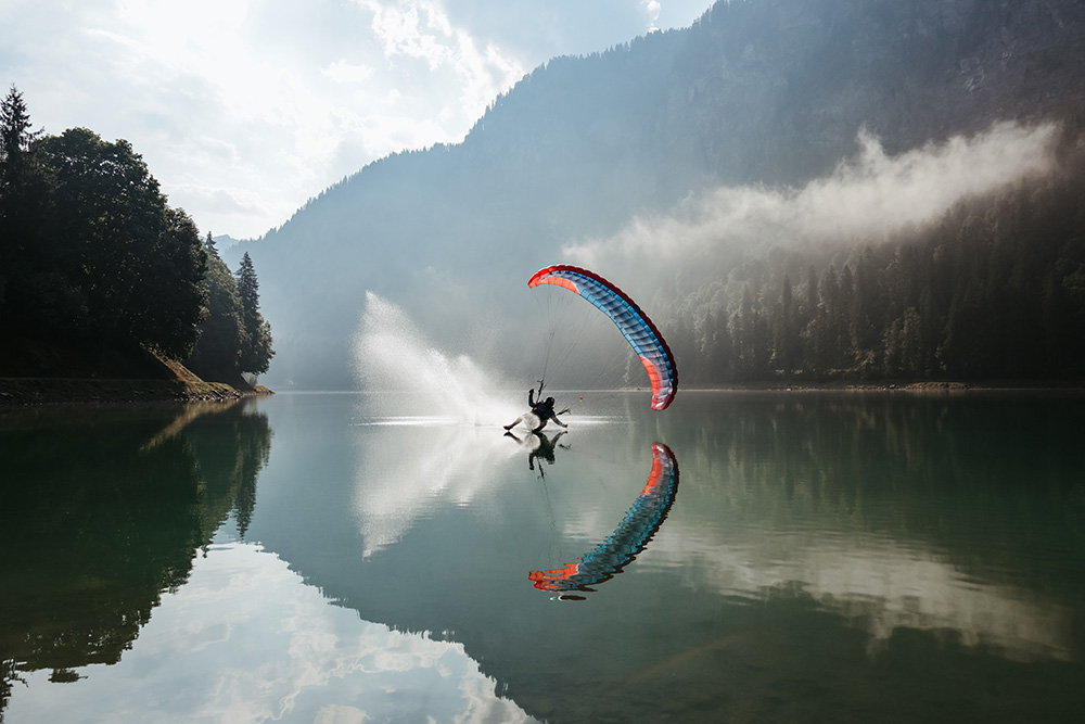 Paraglider captured in a perfect moment over the lake