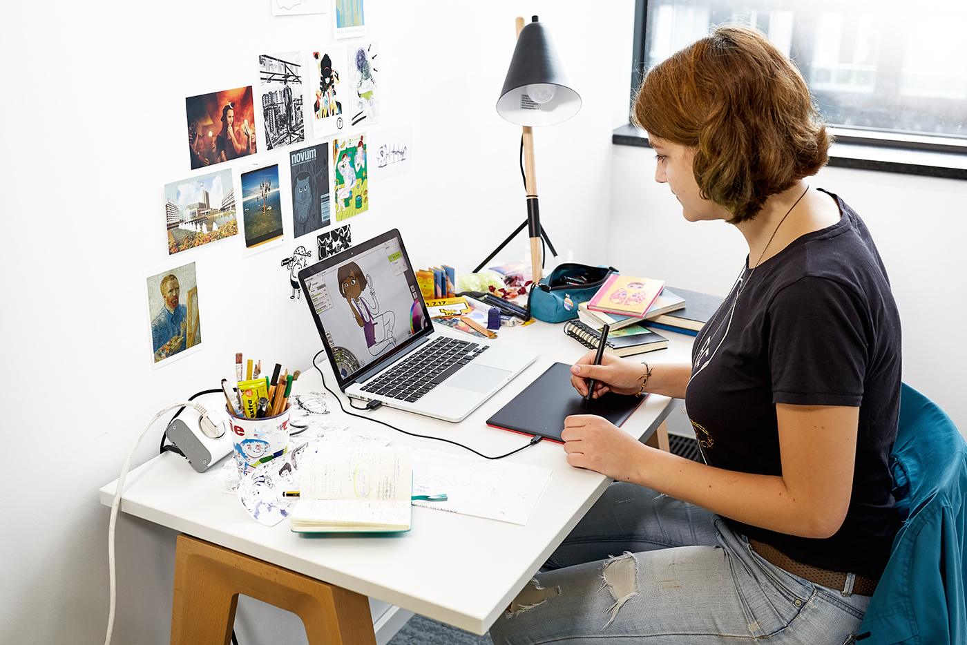 Illustrator working with a tablet pen and mac laptop