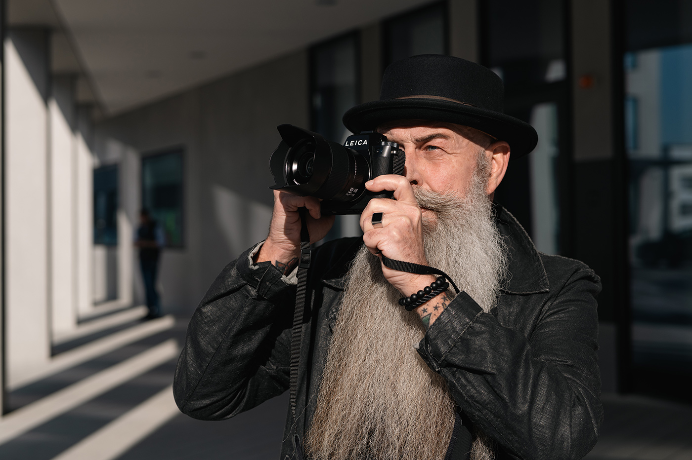 Bearded user with the EVF pressed to their eye